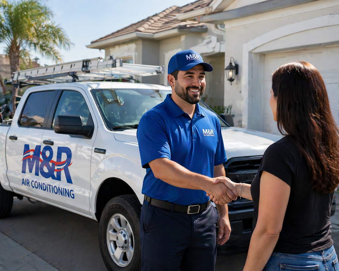 M&R Air Conditioning technician shaking hands with a satisfied customer beside the company truck